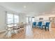 Open-concept dining area adjacent to a modern kitchen with white cabinets and a large island at 131 Brant Dr, Summerville, SC 29483