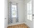 Welcoming entryway with wood floors, a window with patterned curtains, and a white front door at 131 Brant Dr, Summerville, SC 29483