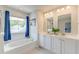 Bright main bathroom with double sinks, a soaking tub, and a separate glass-enclosed shower for ultimate relaxation at 131 Brant Dr, Summerville, SC 29483