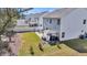Aerial view of the home's backyard, featuring a patio and grassy area, surrounded by a fence and neighborhood at 134 Country Oaks Ln, Wando, SC 29492