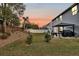 Large backyard with a beautiful orange sunset and well-manicured lawn perfect for relaxation and recreation at 134 Country Oaks Ln, Wando, SC 29492