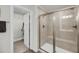 Modern bathroom featuring a glass-enclosed shower and a walk-in closet at 134 Country Oaks Ln, Wando, SC 29492