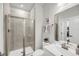 Well-lit bathroom with a glass-enclosed shower, white cabinets, and neutral tile at 134 Country Oaks Ln, Wando, SC 29492