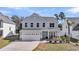 Charming two-story home with a well-manicured front yard and a two-car garage at 134 Country Oaks Ln, Wando, SC 29492