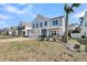 Beautiful home featuring a cozy front porch, a well-kept lawn, and attached garage at 134 Country Oaks Ln, Wando, SC 29492