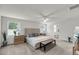 Bright main bedroom featuring a large bed, two windows, and a ceiling fan at 134 Country Oaks Ln, Wando, SC 29492