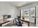 Bright and airy home office space with natural light, wooden desks, and a comfortable chair at 134 Country Oaks Ln, Wando, SC 29492