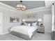 Serene bedroom featuring soft blue tones, a plush bed, and ample natural light from the windows at 135 Royal Cainhoy Way, Huger, SC 29450
