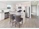 Open kitchen boasts stainless appliances, granite countertops, and a central island with seating at 135 Royal Cainhoy Way, Huger, SC 29450