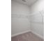 Bright walk-in closet features sturdy white shelving and neutral carpeting at 135 Royal Cainhoy Way, Huger, SC 29450
