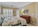 Comfortable bedroom featuring a bed with quilt, window with shutters and bedside table at 1413 Basildon Rd, Mount Pleasant, SC 29466