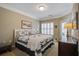 Comfortable bedroom featuring a bed with quilt, window with shutters and bedside table at 1413 Basildon Rd, Mount Pleasant, SC 29466