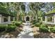 Inviting community area with stone pathway leading to cozy seating and fire pit, surrounded by lush landscaping and trees at 1413 Basildon Rd, Mount Pleasant, SC 29466