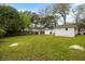 Expansive backyard with green lawn, mature trees, and storage shed, offering a serene outdoor space at 1423 Bexley St, North Charleston, SC 29405