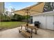 Charming backyard patio features a wooden picnic table with umbrella, a barbecue grill, and lush green lawn at 1423 Bexley St, North Charleston, SC 29405