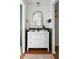 Stylish bathroom featuring green wainscoting, a white vanity with gold mirror, and decorative accessories at 1423 Bexley St, North Charleston, SC 29405