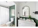 Charming bathroom with elegant white vanity, a gold framed mirror, and a shower with white curtain at 1423 Bexley St, North Charleston, SC 29405