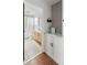 Bathroom features a stylish vanity with marble countertop, patterned wallpaper, and doorway to a tiled shower/tub area at 1423 Bexley St, North Charleston, SC 29405