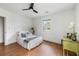 Bright bedroom with white bedding, wood floors, and a window with natural light at 1423 Bexley St, North Charleston, SC 29405