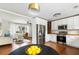 Open-concept kitchen with white cabinets, butcher block counters, and stainless steel appliances at 1423 Bexley St, North Charleston, SC 29405