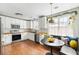 Modern kitchen with white cabinets, stainless steel appliances, and a cozy dining area at 1423 Bexley St, North Charleston, SC 29405