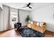 Bright living room featuring hardwood floors, comfortable seating, and a ceiling fan at 1423 Bexley St, North Charleston, SC 29405