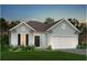 Charming single Gathering home with two-car garage and beautifully landscaped front yard at 152 Royal Cainhoy Way, Huger, SC 29450
