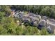 Aerial view of residential neighborhood featuring lush green trees and well-maintained townhomes at 155 Village Ponds Dr, Summerville, SC 29483