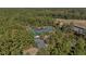 Aerial view of building surrounded by lush forest and a paved drive at 155 Village Ponds Dr, Summerville, SC 29483