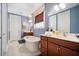 Bright bathroom featuring a standalone tub, double vanity with wood cabinets, and tiled floor at 155 Village Ponds Dr, Summerville, SC 29483