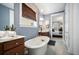 Bright bathroom featuring a standalone tub, double vanity with wood cabinets, and view into bedroom at 155 Village Ponds Dr, Summerville, SC 29483