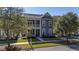 Inviting two-story house featuring a cozy front porch, well-maintained lawn, and mature trees at 155 Village Ponds Dr, Summerville, SC 29483