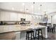 Bright eat-in kitchen featuring granite countertops, stainless steel appliances, and a functional center island with seating at 155 Village Ponds Dr, Summerville, SC 29483