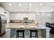 Bright eat-in kitchen featuring granite countertops, stainless steel appliances, and a functional center island with seating at 155 Village Ponds Dr, Summerville, SC 29483