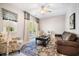 Cozy living room with hardwood floors, comfortable seating, and natural light from a window at 155 Village Ponds Dr, Summerville, SC 29483