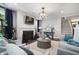 Cozy living room with fireplace, neutral decor, and large windows at 155 Village Ponds Dr, Summerville, SC 29483