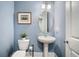Powder room featuring blue walls, pedestal sink, and toilet at 155 Village Ponds Dr, Summerville, SC 29483