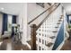 Staircase with white banister and dark wood railing leading to the upper level of the home at 155 Village Ponds Dr, Summerville, SC 29483