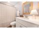 Bathroom vanity with white countertop, framed mirror, decorative lamp, and shower with patterned curtain at 162 Winding River Dr, Johns Island, SC 29455