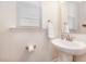 Clean and modern half bathroom features a pedestal sink and ample natural light at 162 Winding River Dr, Johns Island, SC 29455