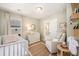 Cozy Bedroom with crib, changing table, rocker, decorative rug, and natural light at 162 Winding River Dr, Johns Island, SC 29455