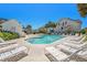 Community pool area with lounge chairs, palm trees, and nearby buildings at 162 Winding River Dr, Johns Island, SC 29455