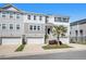 Attractive townhome with white siding, garage, and front stairs leading to the front door at 162 Winding River Dr, Johns Island, SC 29455