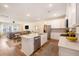 Open-concept kitchen with stainless appliances, island, breakfast bar, and connecting living area at 162 Winding River Dr, Johns Island, SC 29455