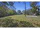 Spacious backyard featuring a basketball court, lawn and wood privacy fence at 1634 Sumner Ave, North Charleston, SC 29406