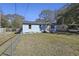 Charming blue home with fenced yard and mature trees at 1634 Sumner Ave, North Charleston, SC 29406