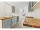 Bright kitchen featuring gray cabinets with butcher block countertops at 1634 Sumner Ave, North Charleston, SC 29406