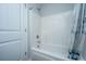 Clean white bathtub with chrome fixtures, shower curtain, and a white door next to it at 164 Buchanan Cir, Goose Creek, SC 29445