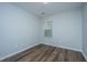 Cozy bedroom with wood floors, a window providing natural light, and neutral wall color at 164 Buchanan Cir, Goose Creek, SC 29445