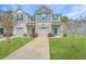 Charming townhomes featuring gray siding, garage, blue accents, and well-maintained landscaping at 164 Buchanan Cir, Goose Creek, SC 29445